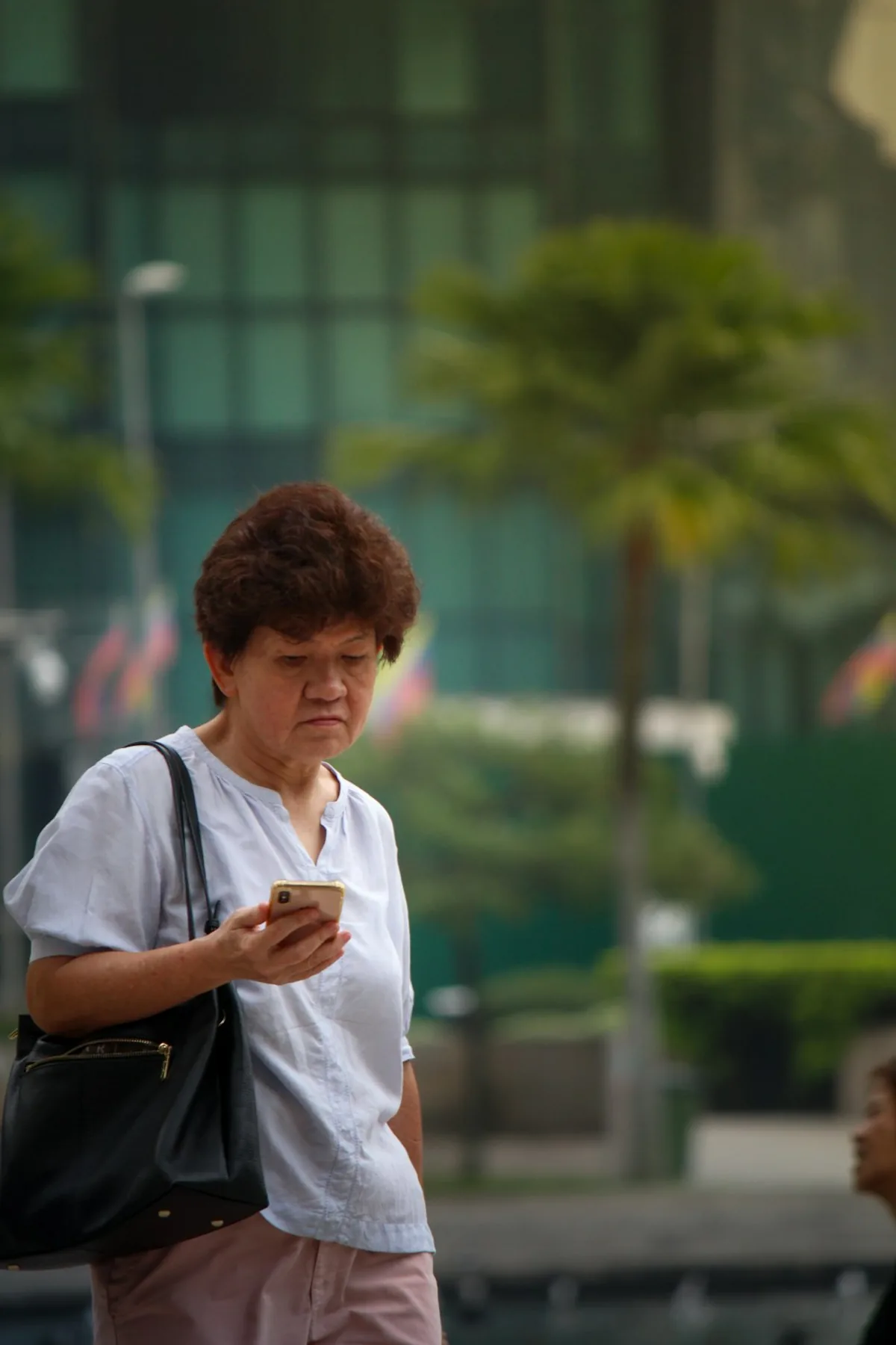 スマートフォンで家族と連絡をとる高齢女性