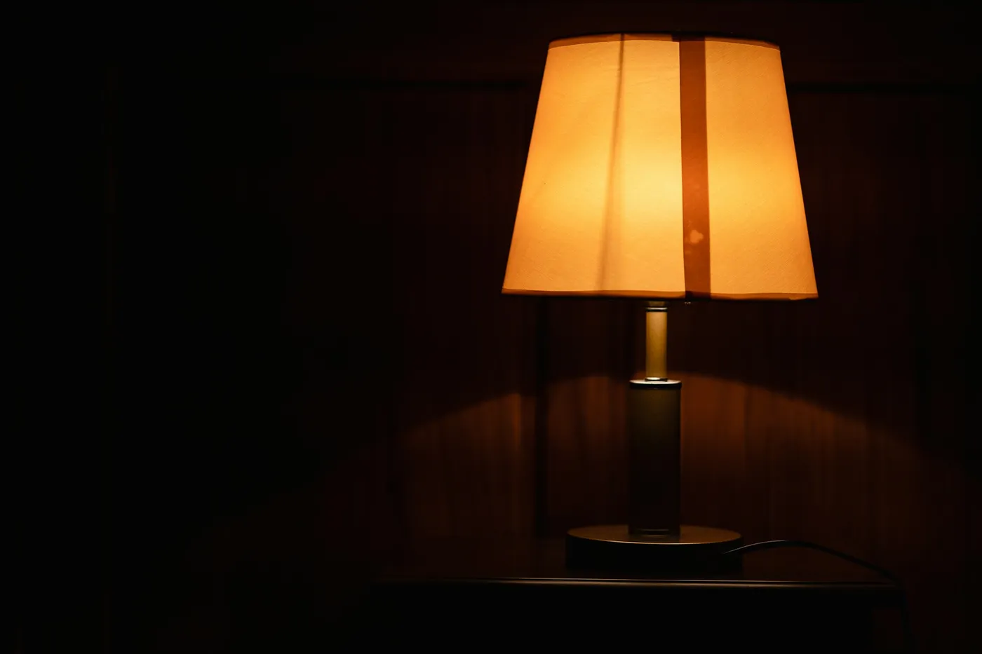 暗い部屋に灯った、枕元のスタンドの明かり